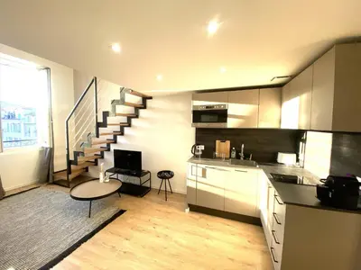 a kitchen with a staircase and a living room at Lamartine hypercentre 503 in Nice