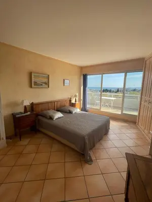 a bedroom with a bed and a large window at PENTHOUSE DUPLEX T3 SUNSEA in Cagnes-sur-Mer