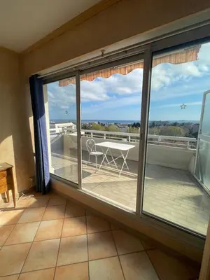 a view from the balcony of a room with sliding glass doors at PENTHOUSE DUPLEX T3 SUNSEA in Cagnes-sur-Mer