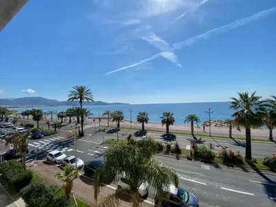 a view of a parking lot with palm trees and the ocean at PENTHOUSE DUPLEX T3 SUNSEA in Cagnes-sur-Mer
