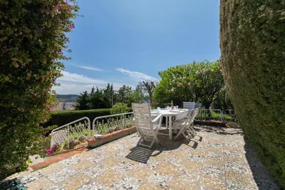 a table and chairs sitting on a stone patio at Maison Bianchi - Villa Saint Pierre de Feric in Nice