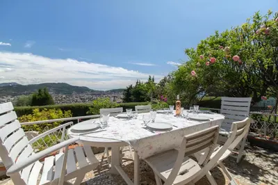 a white table with white chairs sitting on a balcony at Maison Bianchi - Villa Saint Pierre de Feric in Nice