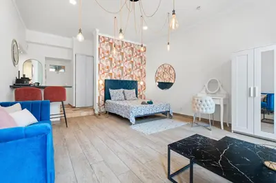 a living room with a blue couch and a table at Nice Renting - 2 MASSENA - Luxury Loft - Balcony Massena Square View - AirCon in Nice