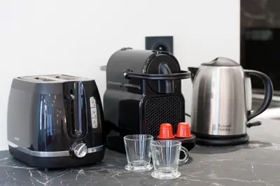 a toaster and coffee maker sitting on a counter at Nice Renting - 2 MASSENA - Luxury Loft - Balcony Massena Square View - AirCon in Nice