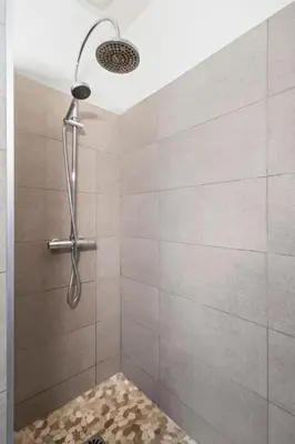 a bathroom with a shower with a shower head and a shower at Nice Renting - 2 MASSENA - Luxury Loft - Balcony Massena Square View - AirCon in Nice