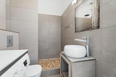 a bathroom with a sink and a toilet and a mirror at Nice Renting - 2 MASSENA - Luxury Loft - Balcony Massena Square View - AirCon in Nice