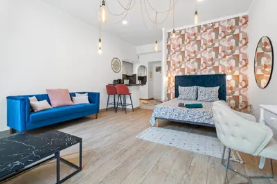a living room with a blue couch and a table at Nice Renting - 2 MASSENA - Luxury Loft - Balcony Massena Square View - AirCon in Nice