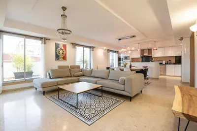 a living room with a couch and a table at Chauvain Résidence in Nice