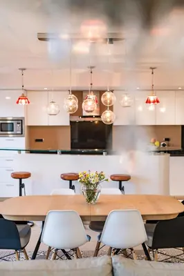 a kitchen and dining room with a table and chairs at Chauvain Résidence in Nice