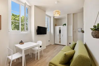 a living room with a couch and a table at Residence Massena in Nice