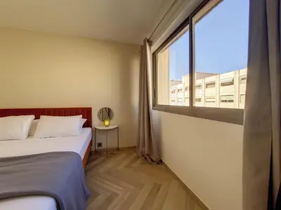 a bedroom with a bed and a large window at Nestor&Jeeves - BELLE ETOILE - Central - Premium in Nice