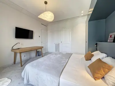 a bedroom with a large white bed and a desk at Nestor&Jeeves - SEAHORSE - Central - Proche mer in Nice