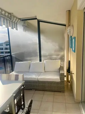 a couch sitting on top of a balcony at Front sea Luxury in Cagnes-sur-Mer
