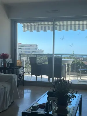 a living room with a view of a piano at Front sea Luxury in Cagnes-sur-Mer