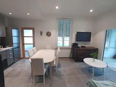 a kitchen and dining room with a white table and chairs at appartement nice in Nice