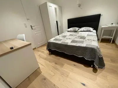 a bedroom with a bed with a black and white quilt at appartement nice in Nice