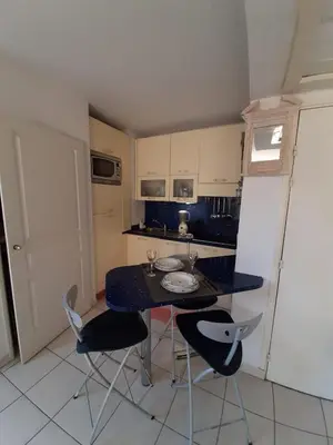 a small kitchen with a table and chairs in it at studio joli in Nice
