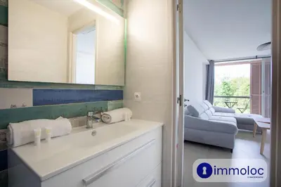 a bathroom with a sink and a mirror at Air-conditioned studio 5 minutes from the beach and shops in Cros-de-Cagnes