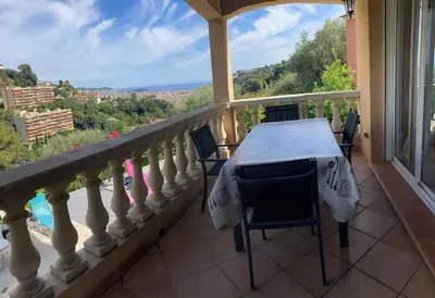 a balcony with a table and chairs and a view at Villa avec piscine et vue magnifique sur Nice in Nice