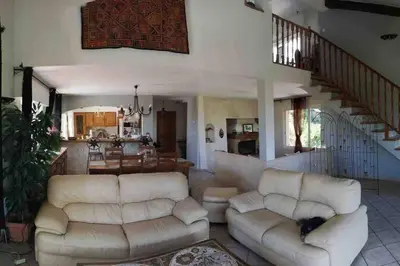 a living room with two white couches and a staircase at Villa avec piscine et vue magnifique sur Nice in Nice