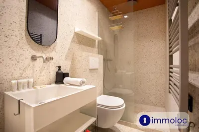 a bathroom with a sink and a toilet and a mirror at Air-conditioned apartment in Old Nice in Nice