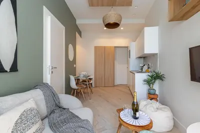 a living room with a couch and a table at Charming Central 1 Bdr in Nice