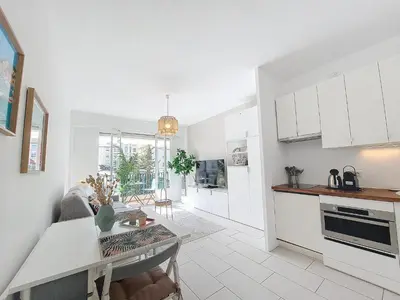 a kitchen and living room with white cabinets at Nestor&Jeeves - STUDIO RIVIERA - Central - Very close sea in Nice