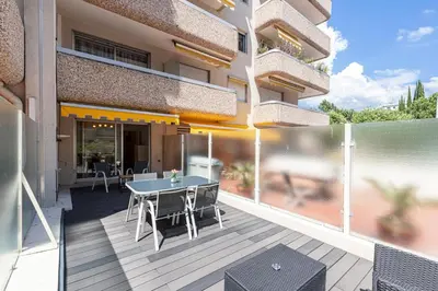 a balcony of a building with a table and chairs at 1 Bdr Large Terrace in Nice