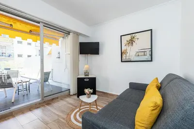 a living room with a couch and a table at 1 Bdr Large Terrace in Nice