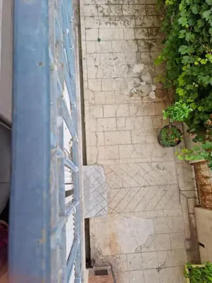 an overhead view of a brick walkway next to a building at Appartement 2 pieces in Nice