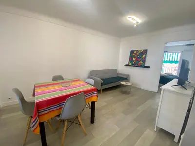 a living room with a table and a couch at Suite Gloria Five stars holiday house in Nice