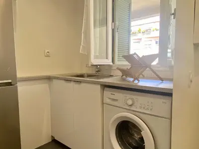 a kitchen with a washing machine and a sink at Suite Gloria Five stars holiday house in Nice