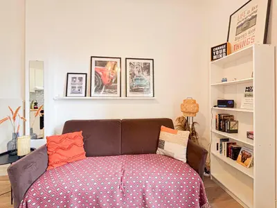 a bedroom with a couch with pillows on it at Cosy 2 pieces rénové, Proche mer, 4 pers in Nice