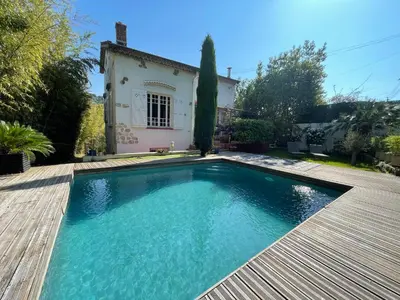 a swimming pool in front of a house at Souvenir à jamais ! in Nice