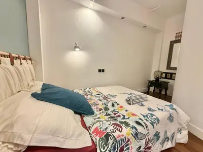 a bedroom with a bed with a comforter on it at Souvenir à jamais ! in Nice