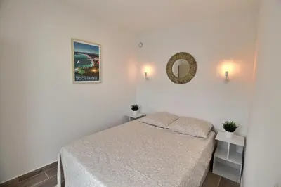 a bedroom with a bed and a mirror on the wall at Cosy appartement en plein coeur de la libération in Nice