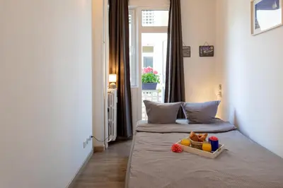 a bedroom with a bed with a tray of food on it at BEAUTIFUL apartment , beach 3 min walk , free parking, near Negresco in Nice