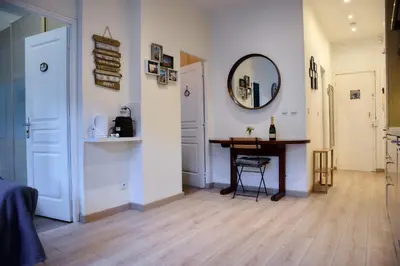a room with a table and a mirror on the wall at BEAUTIFUL apartment , beach 3 min walk , free parking, near Negresco in Nice