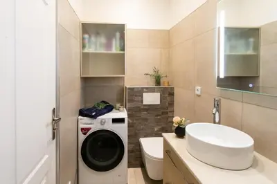 a bathroom with a washing machine and a sink at BEAUTIFUL apartment , beach 3 min walk , free parking, near Negresco in Nice