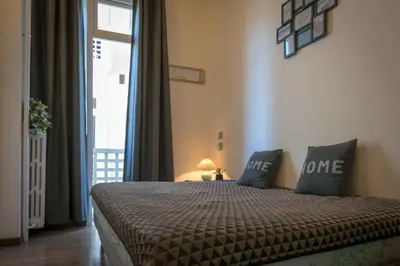 a bedroom with a bed and a window at BEAUTIFUL apartment , beach 3 min walk , free parking, near Negresco in Nice