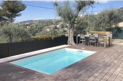a swimming pool on a deck with a table and chairs at Nice, Magnifique villa vue mer avec piscine in Nice
