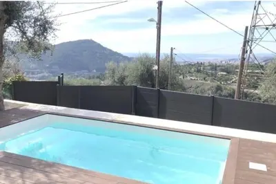 a swimming pool with a view of a mountain at Nice, Magnifique villa vue mer avec piscine in Nice