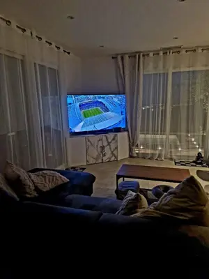 a living room with a couch and a flat screen tv at Nice, Magnifique villa vue mer avec piscine in Nice
