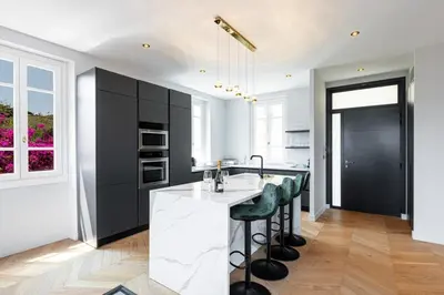 a kitchen with black cabinets and a counter with green bar stools at MY CASA - HSAUVAN - Villa Design Swimming Pool Sea View in Saint-Jean-Cap-Ferrat