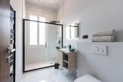 a bathroom with a shower and a toilet and a sink at MY CASA - HSAUVAN - Villa Design Swimming Pool Sea View in Saint-Jean-Cap-Ferrat