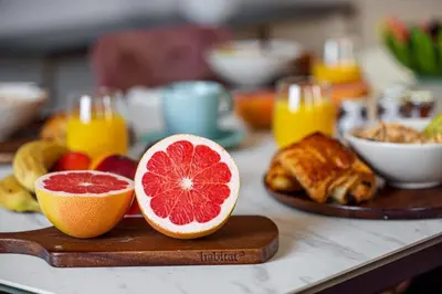 a table with oranges and other fruits on a table at MY CASA - HSAUVAN - Villa Design Swimming Pool Sea View in Saint-Jean-Cap-Ferrat