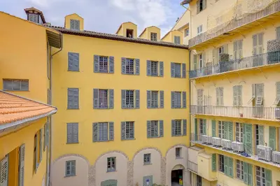 a yellow building with windows and balconies at Maison Bianchi - Jaures Old Town in Nice