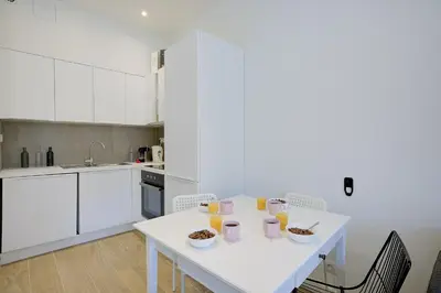 a white kitchen with a table with food on it at Maison Bianchi - Jaures Old Town in Nice