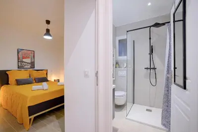 a bedroom with a shower and a bed and a bathroom at Maison Bianchi - Jaures Old Town in Nice