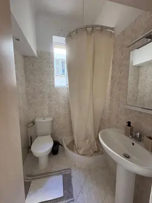 a white bathroom with a toilet and a sink at Studio Au coeur de Nice in Nice